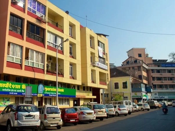 18th June Road Panaji Goa bustling market street with shops, banks and parked cars in city center