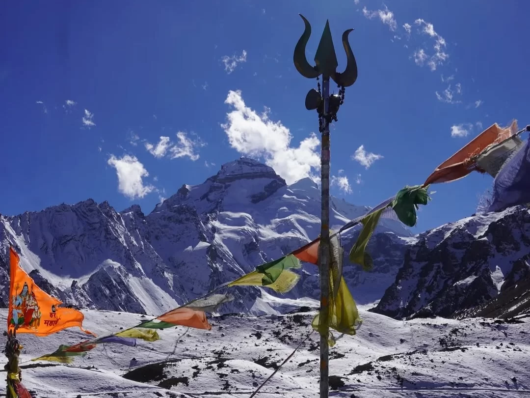 Adi Kailash sacred Himalayan peak with trishul, prayer flags and snow covered mountain view in Uttarakhand tour packages.