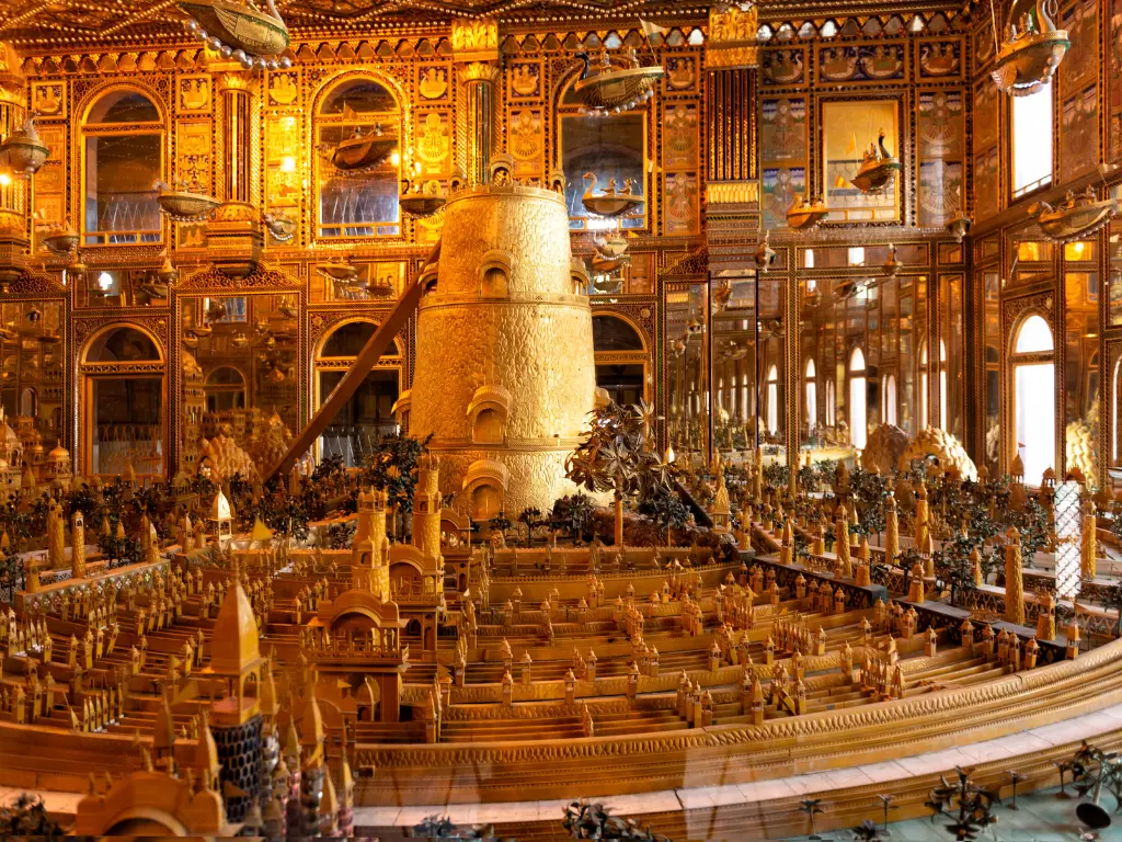 miniature model with tower at Ajmer Soniji ri Jain Temple Rajasthan in golden lighting, featuring ornate arches mirrors and wood carvings, perfect spiritual Rajasthan tour package.