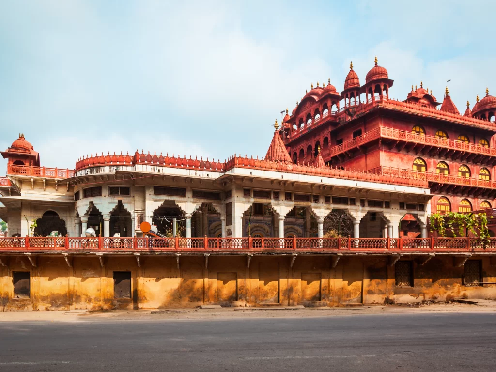 red sandstone complex at Ajmer Soniji ri Jain Temple Rajasthan under partly cloudy skies, featuring multi-domed shikharas and balconies, perfect spiritual Rajasthan tour package.