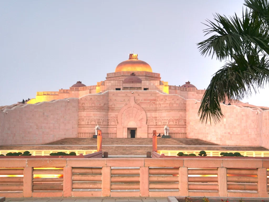 Ambedkar Stupa at memorial park Lucknow during sunset, featuring golden dome pillars palms reflections, perfect cultural Uttar Pradesh tour package.