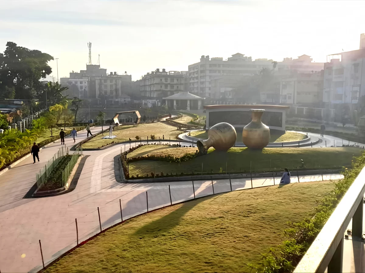 Atal Udyan Adabari Park Guwahati during sunrise, featuring golden ghatchris manicured lawns city skyline, perfect family picnic experience Assam tour package.