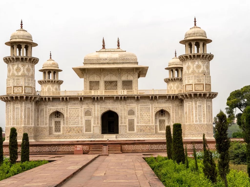 Baby Taj Mahal (Itimad-ud-Daulah Tomb) in Agra during misty weather, featuring marble minarets, gardens, trees, perfect heritage experience Agra tour package.