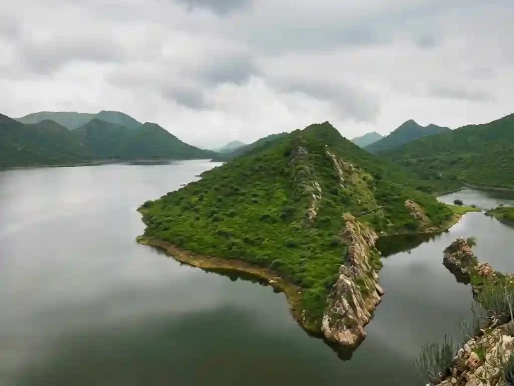 Badi Lake aerial view of the lush green hills surrounding the freshwater lake, a scenic nature spot in Udaipur.
