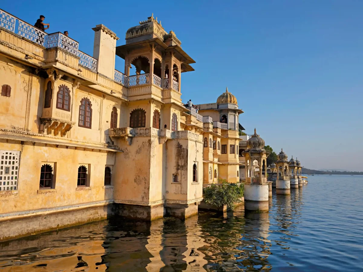 Bagore Ki Haveli waterfront view with traditional stone balconies and chhatris on Lake Pichola, Udaipur, Rajasthan.