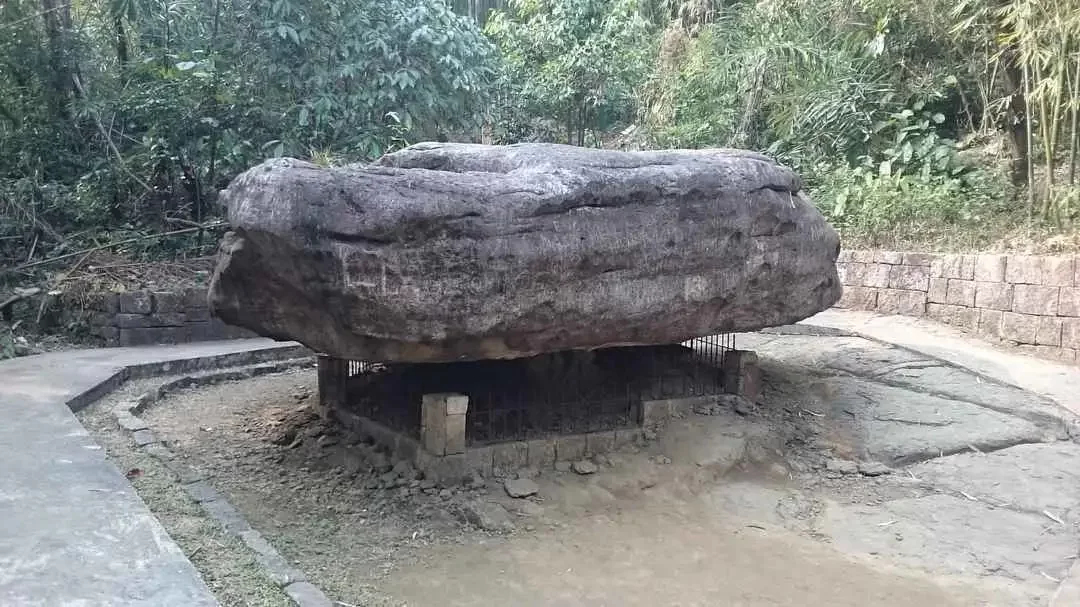 Balancing Rock of Mawlynnong in Meghalaya, massive natural rock perfectly balanced on a smaller base.