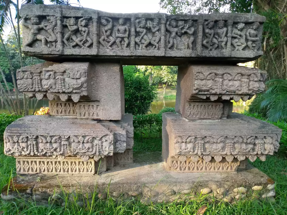Bamuni Hills Tezpur ancient intricately carved stone doorframe sculptures figures palms bushes pond greenery Chitralekha Udyan park, perfect 10th century archaeological gem Assam tour packages.