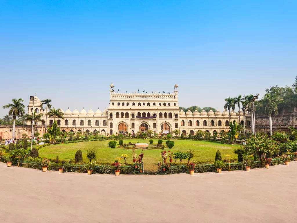 Residentiary Palace at Lucknow during sunny day, featuring white facade domes gardens palms lawns, perfect cultural Uttar Pradesh tour package.