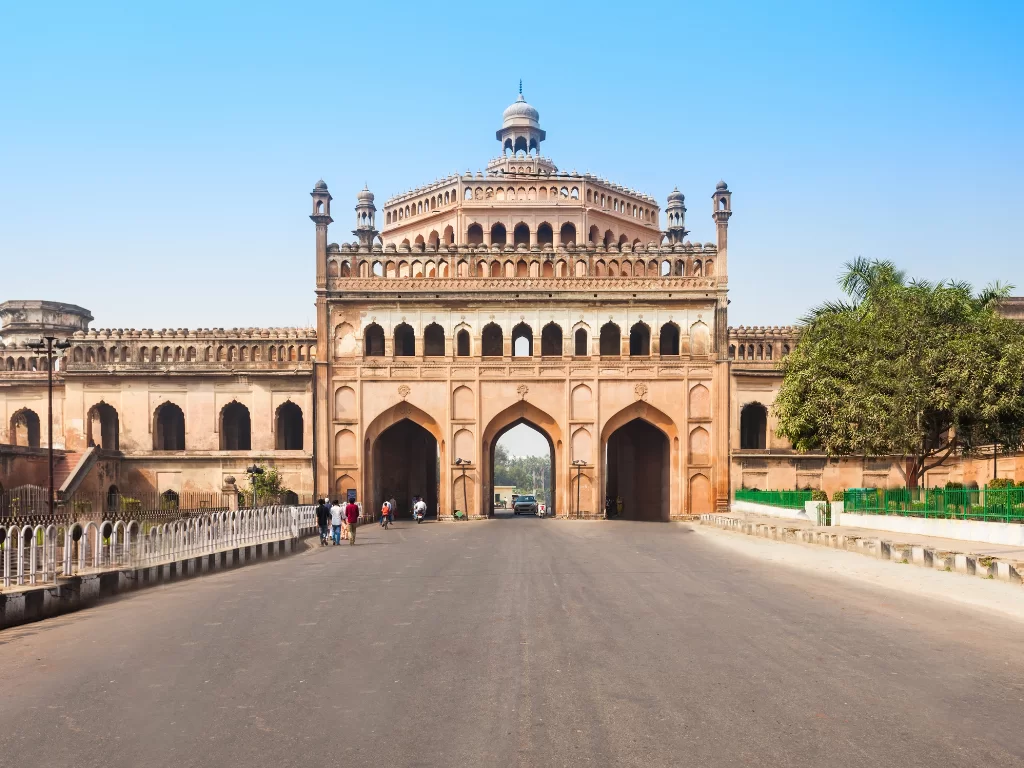 Rumi Darwaza at Bara Imambara Lucknow during sunny day, featuring pink gateway domes trees road crowds, perfect cultural Uttar Pradesh tour package.