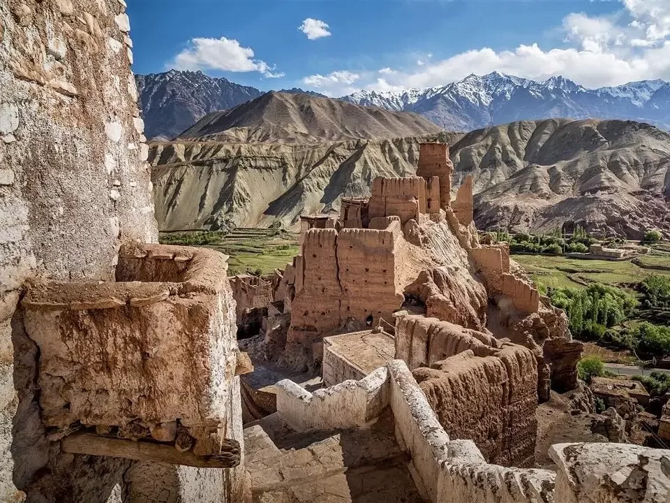 Ancient Basgo Fort ruins at Basgo Monastery Leh Ladakh during clear sky day, featuring multi-tiered earthen walls Indus Valley snowy Zanskar mountains, perfect heritage adventure experience with Basgo Fort Leh tour package.