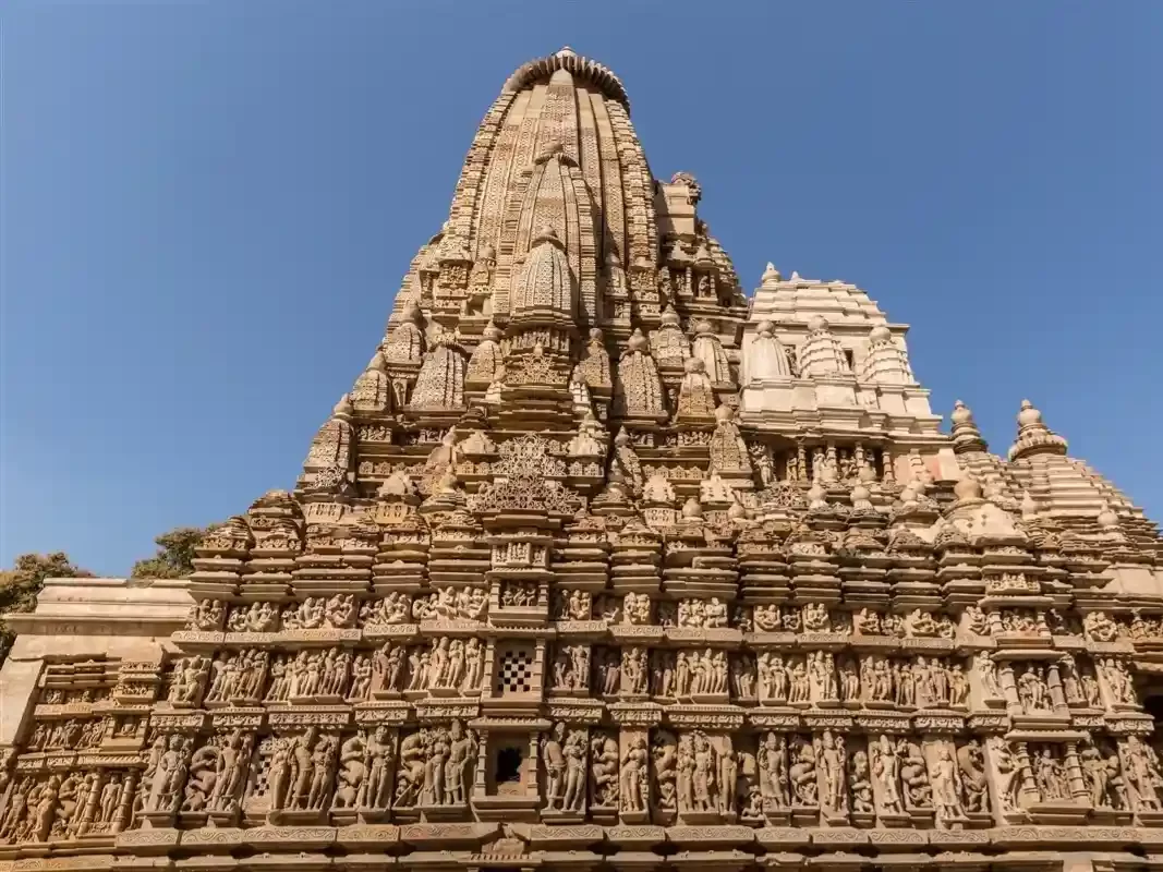 Bhagwan Parshvanath Digambar Jain Mandir in Madhya Pradesh featuring richly carved sandstone shikhara and detailed Jain sculptures, a prominent heritage temple included in Madhya Pradesh tour packages.