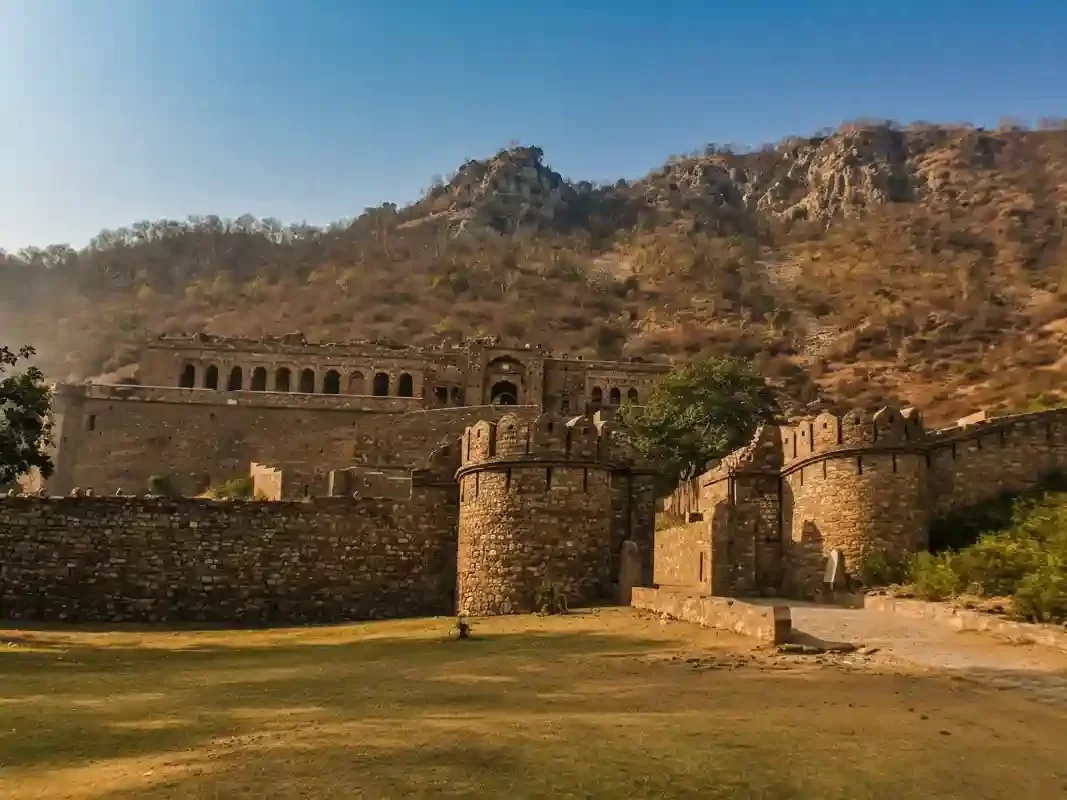 Bhangarh Fort ancient stone ruins and fortified walls at the base of a hill, a famous haunted place in Alwar, Rajasthan.