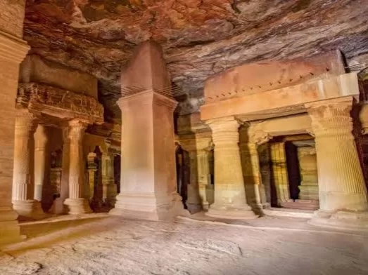 Bhartihari Caves in Madhya Pradesh showcasing ancient rock-cut interiors with carved pillars and stone chambers, a historic site often explored through Madhya Pradesh tour packages.