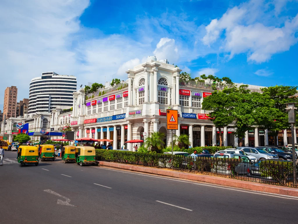 Connaught Place Delhi shopping and business hub with colonial white buildings, markets, restaurants and traffic, popular attraction included in New Delhi city tour packages