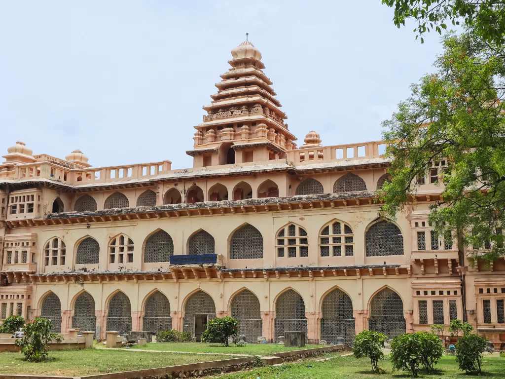 Raja Mahal palace at Chandragiri Fort Tirupati during clear skies, featuring terracotta gopuram and arches, perfect cultural experience Andhra Pradesh tour packages.