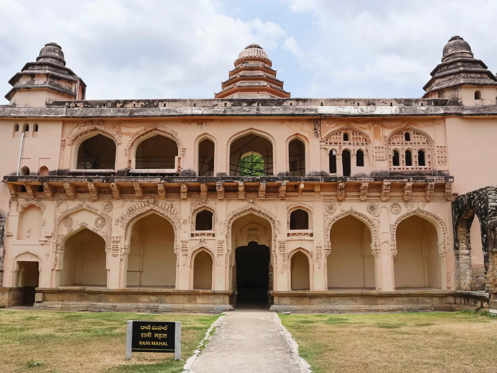 Raja Mahal at Chandragiri Fort Tirupati during partly cloudy day, featuring pink facade and gopurams, perfect cultural experience Andhra Pradesh tour packages.