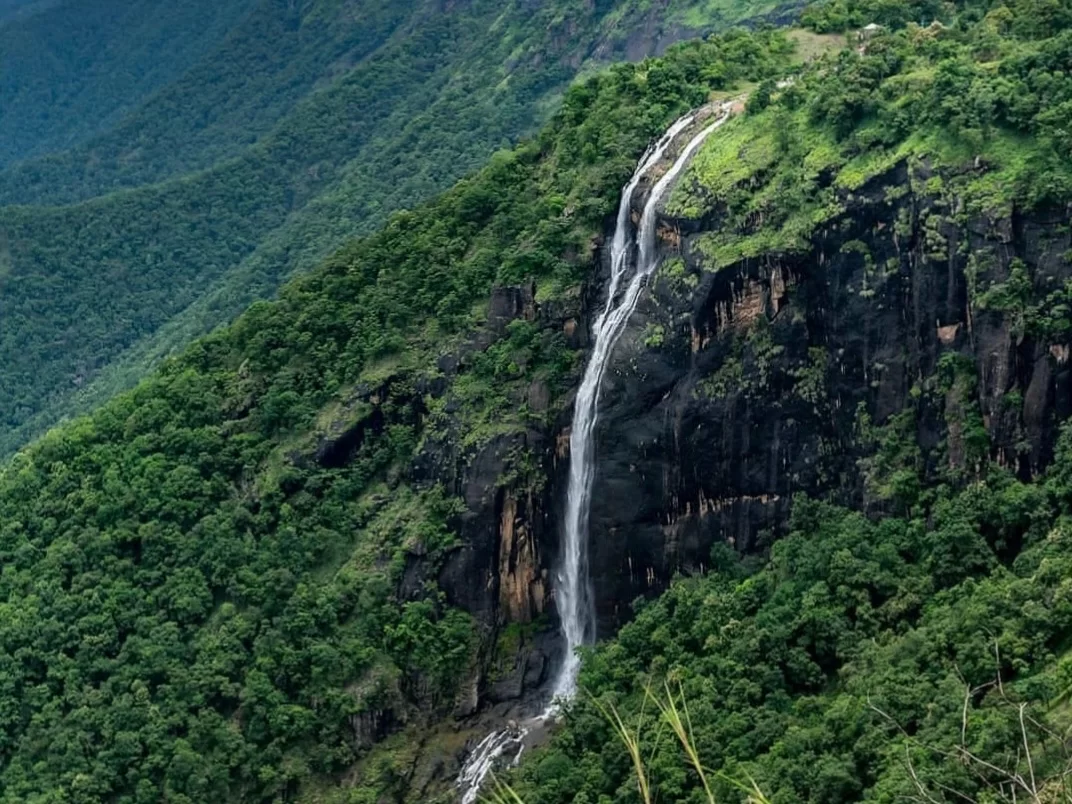 Chellarkovil Waterfall in Kerala, scenic hilltop cascade surrounded by lush Western Ghats greenery.