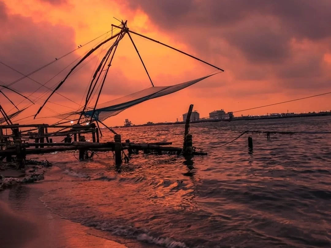 Chinese Fishing Nets in Kochi, iconic sunset view over Arabian Sea with traditional cantilever fishing nets.