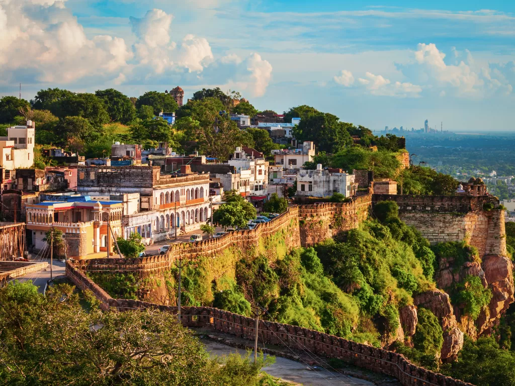 Heritage ramparts of Chittorgarh Fort in Rajasthan under clear sky, featuring ancient walls and city views, perfect Rajasthan tour package.
