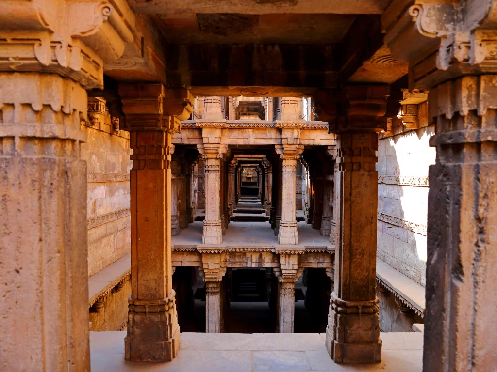 Intricate stepwell at Rani ki Vav Patan during daylight, featuring carved pillars and multi-level arches, perfect cultural Gujarat tour package.