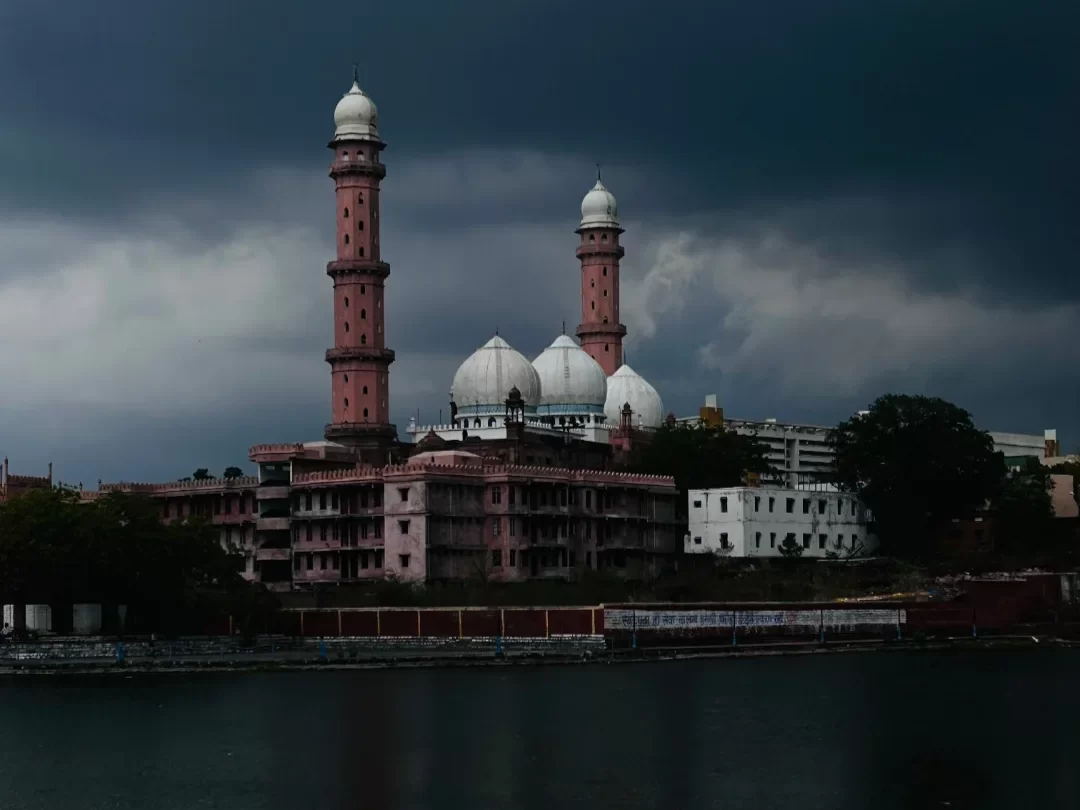 Taj-ul-Masjid in Bhopal, Madhya Pradesh, featuring its grand white domes and tall pink minarets overlooking the lake, a prominent architectural landmark included in Madhya Pradesh tour packages.