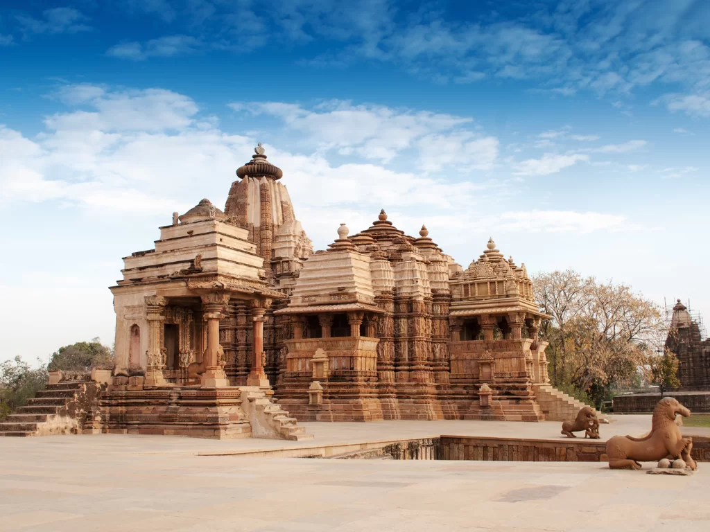 Devi Jagadambi Temple at Khajuraho during clear daylight, featuring Nagara shikhara intricate carvings lion statues, perfect Madhya Pradesh heritage tour package.