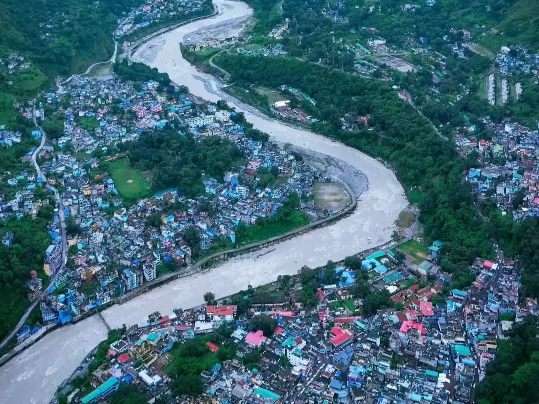 Dharchula aerial view with winding river, town settlement and lush green valley in Uttarakhand tour packages.