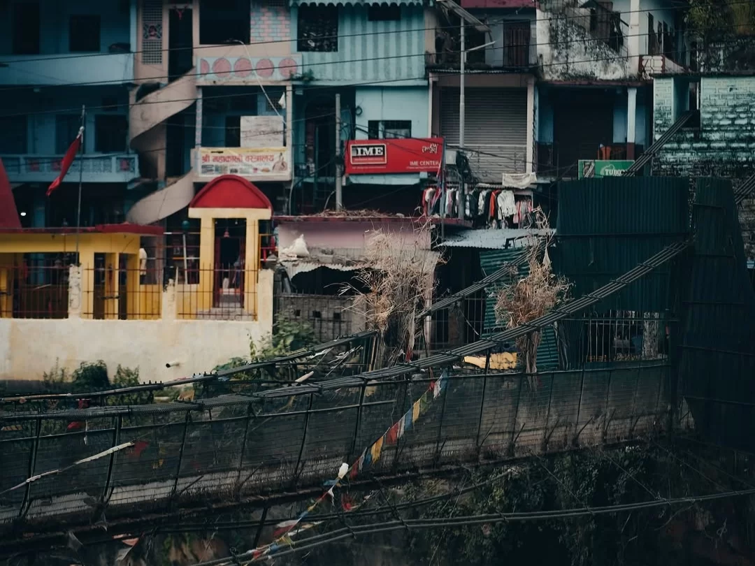 Dharchula town view with riverside houses and suspension bridge in Uttarakhand tour packages.