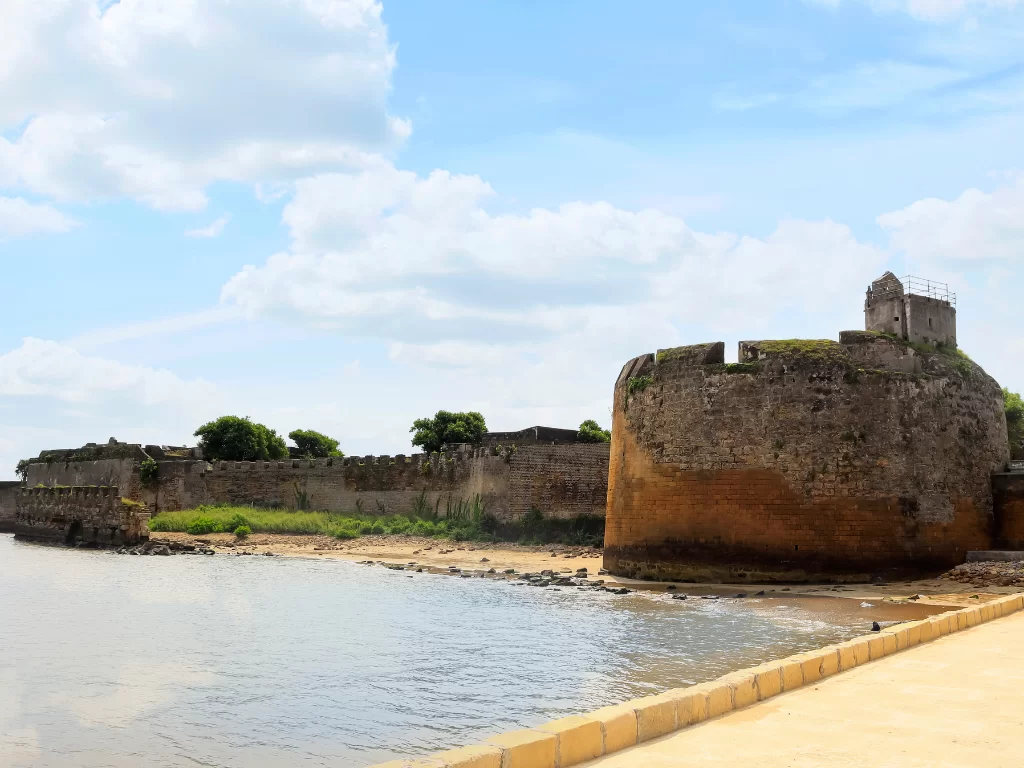 Fortress bastions at Diu Fort during daylight, featuring sea walls and cannon mounts, perfect adventure Diu tour package.