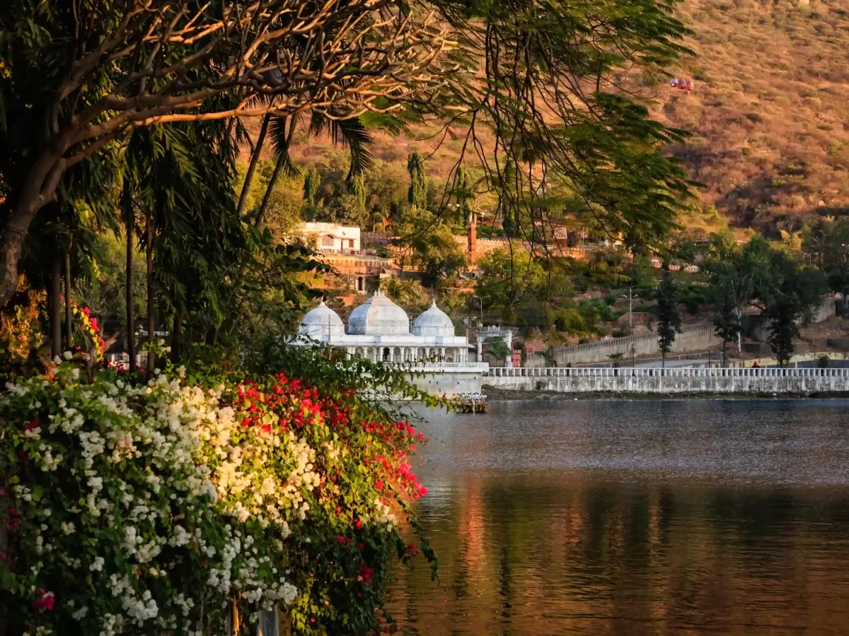 Dudh Talai musical garden and pond view with the Karni Mata ropeway and hilltop views of Lake Pichola in Udaipur.