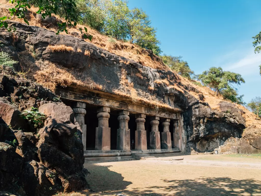 Elephanta Caves Mumbai UNESCO rock-cut temple Shaiva pillars basalt hill greenery, 5th-8th century Trimurti Shiva sculptures Gharapuri island, perfect Gateway India ferry heritage package.