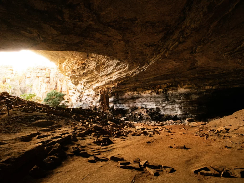 Elephanta Caves Mumbai dramatic cavern light beam rocky interior ancient Shaiva temple, UNESCO rock-cut hall Trimurti Shiva Gharapuri island mystery, perfect cave exploration heritage package.