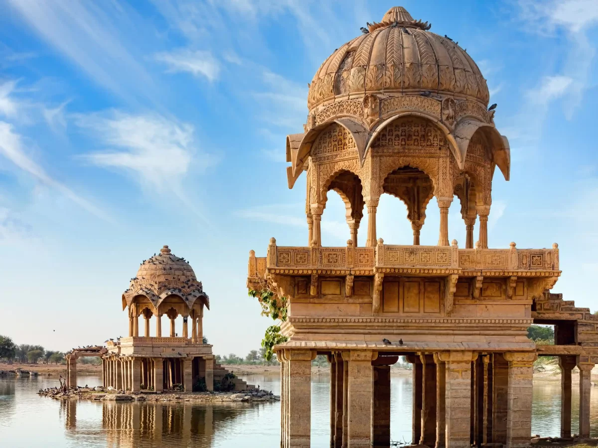 Gadisar Lake historic man-made reservoir surrounded by golden sandstone temples and shrines in Jaisalmer Rajasthan.