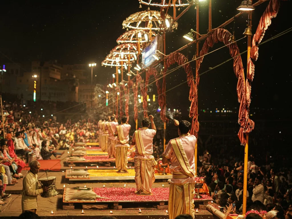 Ganga Aarti ritual at Varanasi during night, featuring priests lamps decorations crowds, perfect spiritual Uttar Pradesh tour package.
