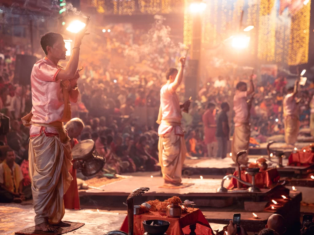 Ganga Aarti ceremony at Varanasi during night, featuring priests flames smoke crowds, perfect spiritual Uttar Pradesh tour package.