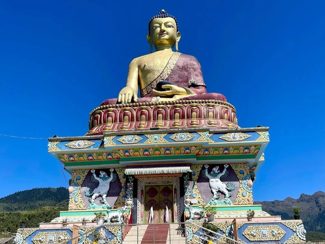 Giant Buddha Statue majestic golden seated Buddha monument against clear blue sky in Arunachal Pradesh Package.
