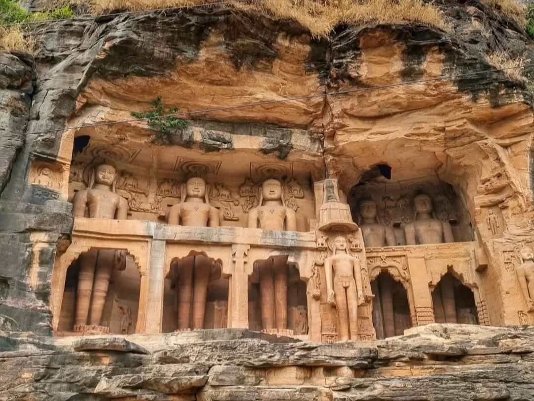  Rock-cut Jain statues at Gopachal Jain Parvat in Gwalior carved into sandstone cliffs, a historic pilgrimage site featured in Madhya Pradesh tour packages