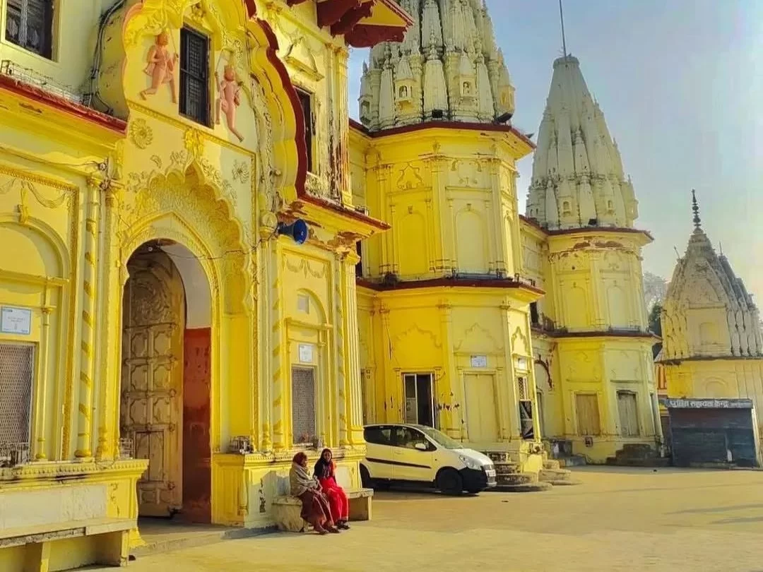 Ornate temple at Guptar Ghat Ayodhya during morning light, featuring multiple shikharas and carvings, perfect cultural experience Uttar Pradesh Tour Packages.