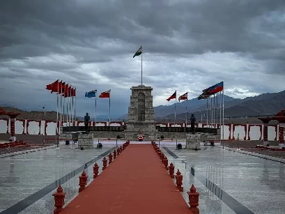Hall of Fame Leh Ladakh Indian Army war memorial cloudy day stone cenotaph multiple nation flags India Pakistan Turkey China snowy Karakoram mountains red carpet lamps soldier statues military museum