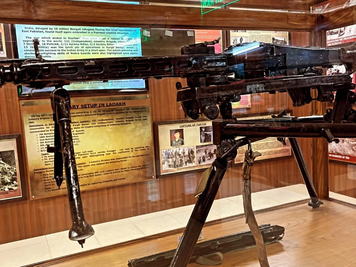 Hall of Fame Leh Ladakh Army setup exhibit captured Pakistani machine gun tripod mount captured weapons display wooden panels informational plaques Siachen operations military history Indian Army museum.