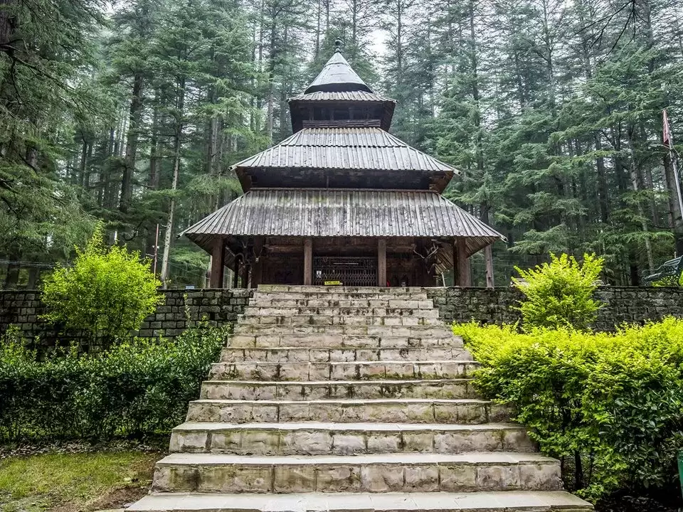 Hidimba Temple at Manali Himachal Pradesh during misty weather, featuring tiered pagoda roof surrounded by deodar trees, ancient sanctuary Incredible India experience Himachal Pradesh tour package.