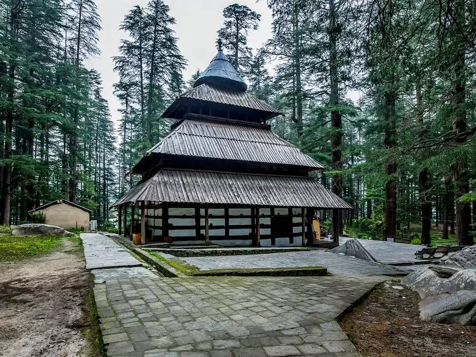 Hidimba Temple at Manali Himachal Pradesh during misty day, featuring tiered wooden roof deodar forest sanctuary, ancient Incredible India experience Himachal Pradesh tour package.