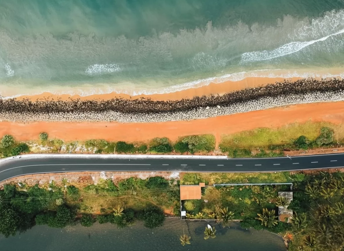 Varkala Beach Kerala aerial coastal road red sands sea breakwaters, turquoise Arabian Sea palms huts backwater greenery, perfect Kerala cliff beach aerial package. 