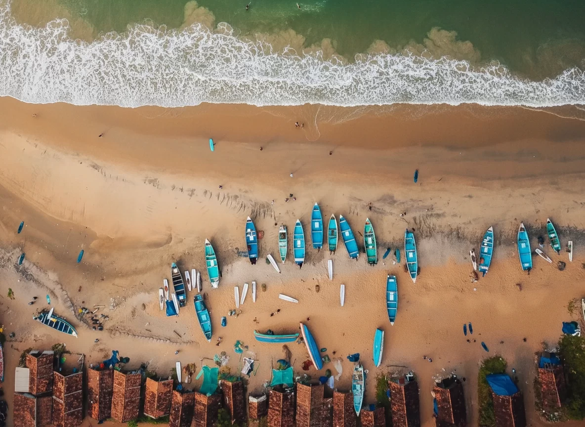 Varkala Beach Kerala aerial fishing boats blue lineup golden sands, traditional huts Arabian Sea waves surfers, perfect Kerala coastal village surf package.