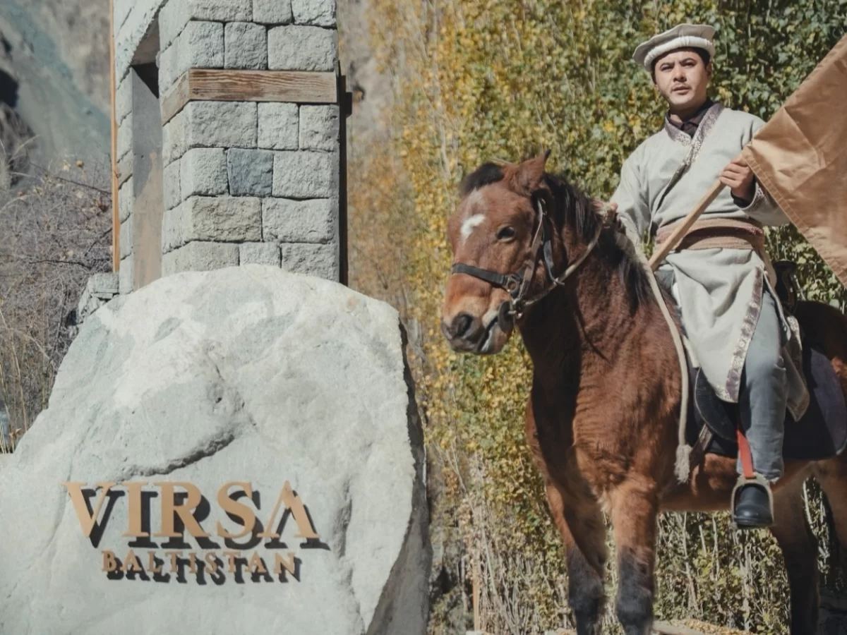 Balti horseman statue at Virsa Baltistan monument in Turtuk village Nubra Valley Ladakh during autumn light, featuring stone arch, apricot trees, perfect cultural Turtuk tour package.