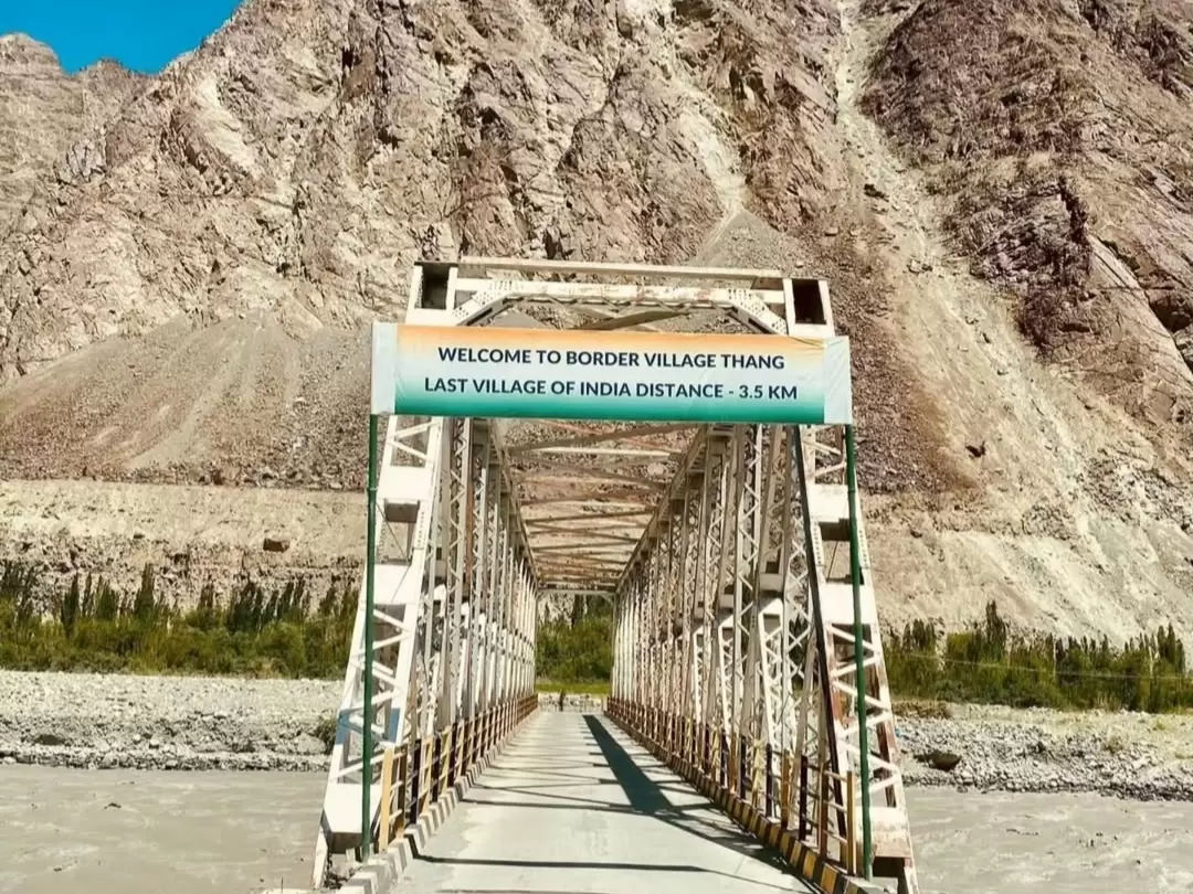 Turtuk village Ladakh Thang border white arch bridge sign Welcome to border village Thang last village of India 3.5 km barren mountains blue skies, perfect northernmost India tour package. 