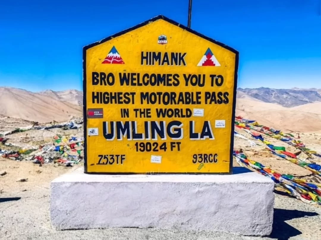 Umling La Ladakh world's highest motorable pass signboard 19300 ft BRO welcome Himalayas, Changthang plateau adventure peak flags desert mountains, perfect Ladakh biking expedition package