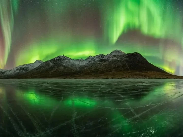 Hanle Ladakh airglow atmospheric glow green aurora snowy mountains icy lake reflection cosmic phenomenon observatory skies, IIA dark sky reserve rare celestial display, perfect stargazing astrophotography package.