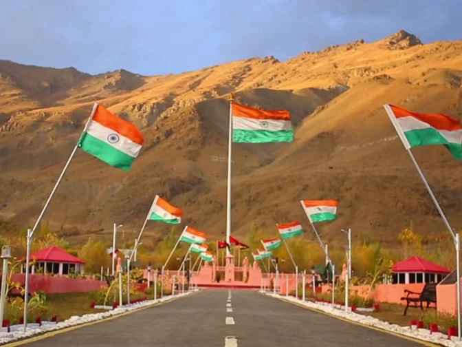 Drass War Memorial Ladakh Indian flags fluttering mountain backdrop pink pavilions pathway gardens patriotic monument Kargil War heroes, perfect Ladakh heritage tour package. ​