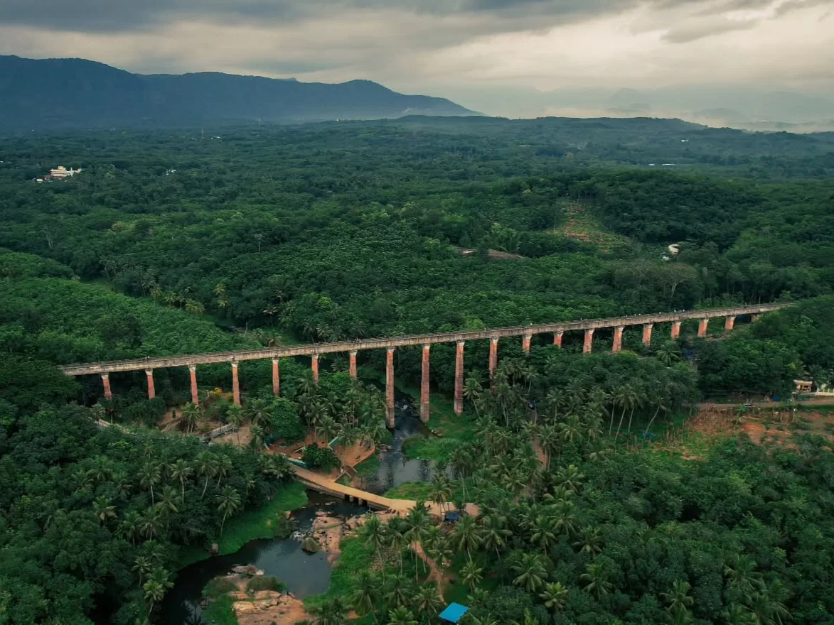 Mathoor Aqueduct Tamil Nadu Asia's longest tallest trough bridge 115ft high 1km long over Pahrali River lush Western Ghats greenery cloudy hills river valley aerial view Kanyakumari district engineering marvel.